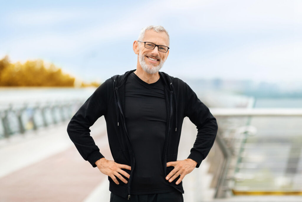 happy-athletic-senior-sportsman-jogging-by-street-2025-03-18-16-11-25-utc (1)