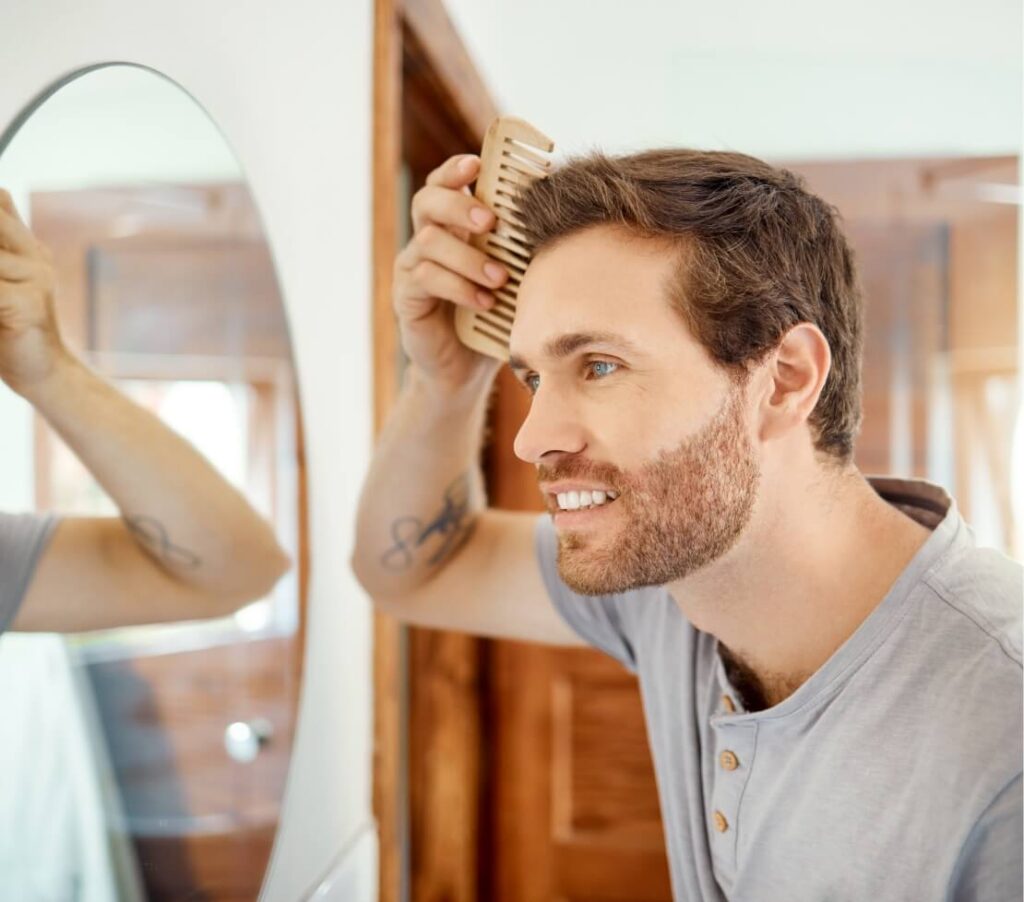 one-handsome-man-combing-his-hair-in-a-bathroom-at-2023-11-27-04-57-20-utc (2)